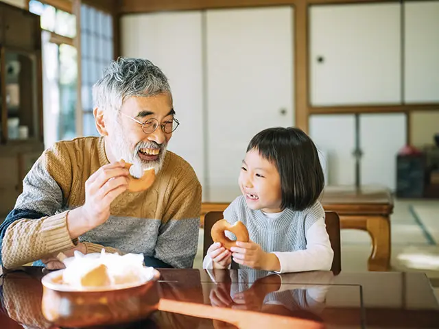 スイーツを食べる祖父と孫